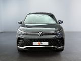 the front view of a grey volkswagen suv parked in a showroom