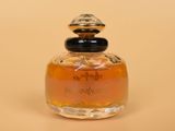 an image of a bottle of perfume sitting on top of a table