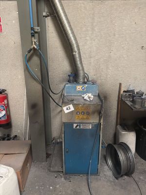 a blue machine that is sitting in a garage