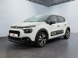 the white citrole is parked in a large room