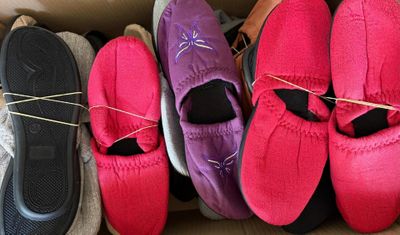 several pairs of shoes are lined up in a cardboard box