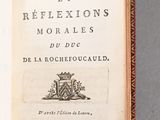 an open book with a picture of a man in a hat on top of it
