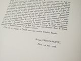 an open book with a black and white image of a person ' s hand holding a pen