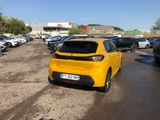 the yellow car is parked in the parking lot next to other cars