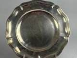silver plate with scalloped edge on stand