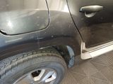 a black car that has been painted black and is parked in a garage