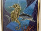 painting of a sea horse and a fish in a gold frame
