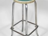 an image of a metal stool with a green seat on a white background