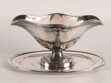 a silver plate with a silver saucer on it