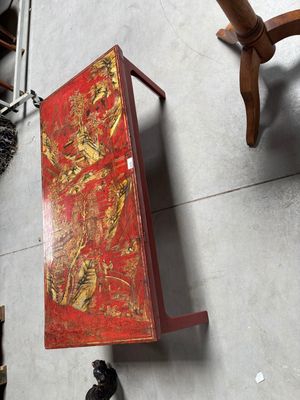 une boîte rouge posée par terre à côté d'autres objets