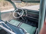 a view of the inside of an old car from the driver ' s seat
