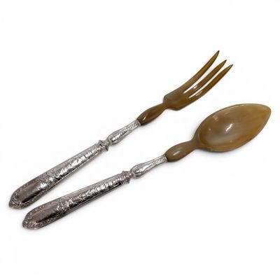 two forks and spoons are sitting next to each other on a white surface