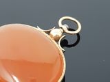 a picture of a pendant with an orange stone on it