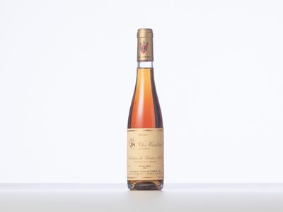 the bottle of wine is sitting on the table with a white background
