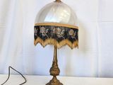 a lamp that is sitting on a table next to a pair of scissors