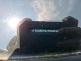someone taking a picture of themselves in the rear view mirror of a car
