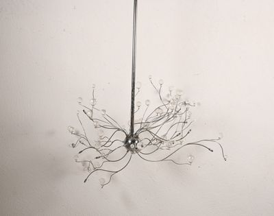 a glass chandelier hanging from the ceiling in a room