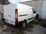 a white van parked in front of a building