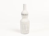 une bouteille blanche sur laquelle est inscrit un message