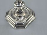 an image of a silver candle holder sitting on a table