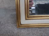 a reflection of a person taking a picture in a mirror