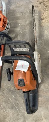 an image of a chainsaw and a chainsaw on the ground