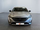 the front view of a silver car parked in a showroom