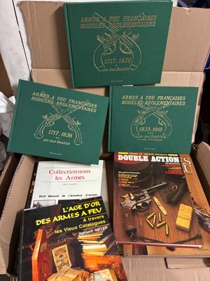 Plusieurs livres sont empilés les uns sur les autres dans une boîte en carton
