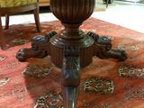 a wooden table with a glass top sitting on a rug