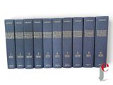 six blue books are lined up in a row on a white surface