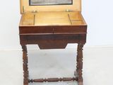 a small wooden table with a mirror on top of it