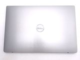 dell laptop computer sitting on a white surface with a dell logo on the screen