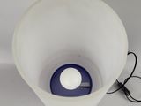an image of a white and blue lamp on a table