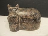 a cat sitting on top of a box on a table