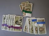 several bills of money are laid out on a table