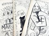 three books with drawings on them on a table