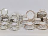 many plates and cups and saucers on the table