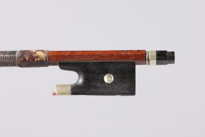 a bow that is attached to a string with a piece of wood on it