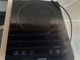 a black stove top with a black burner on it