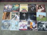 a lot of pink floyd album covers on the floor