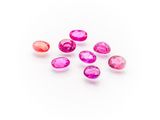 a group of pink and red gems on a white surface