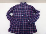 a blue and red plaid shirt sitting on top of a white table