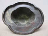 a metal bowl that is sitting on a table