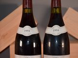 two bottles of wine sitting next to each other on a table