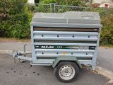 a trailer with a trailer attached to it in the parking lot