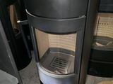 a black stove with a glass door and a box of donuts