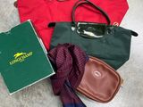 un sac à main, un livre, une écharpe et une paire de lunettes par terre