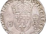 a silver coin with a crown on top of it