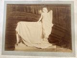 an old photo of a woman laying on a blanket
