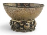 a metal bowl with a bird design on it